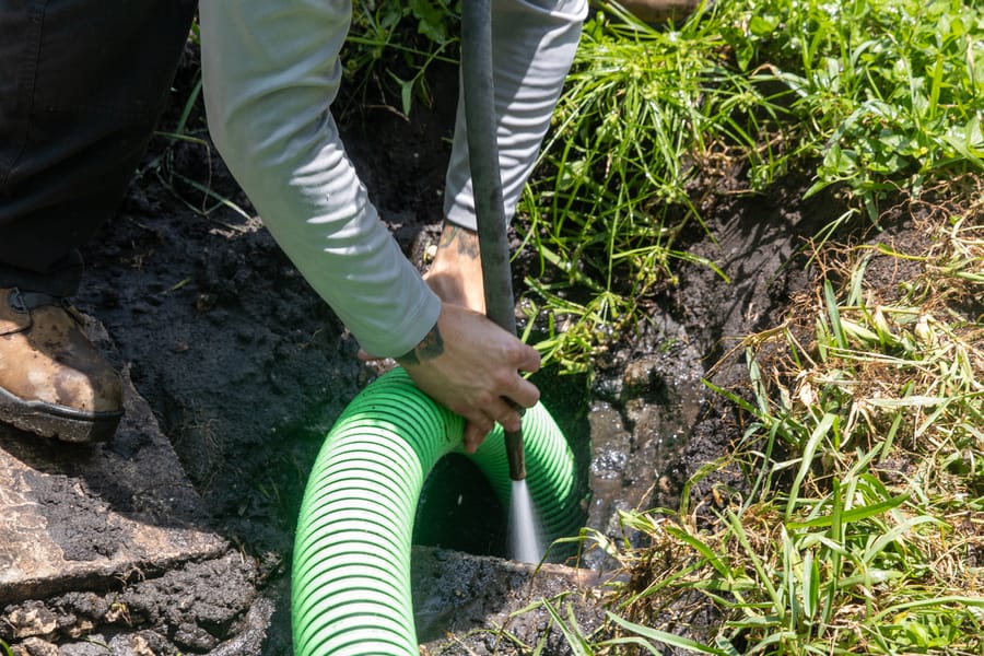 Hydrojetting hose in the open dirt ground.