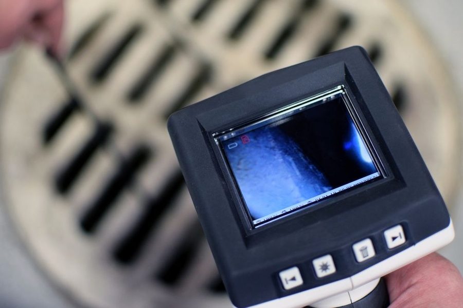 Plumber using camera technology to inspect a sewer